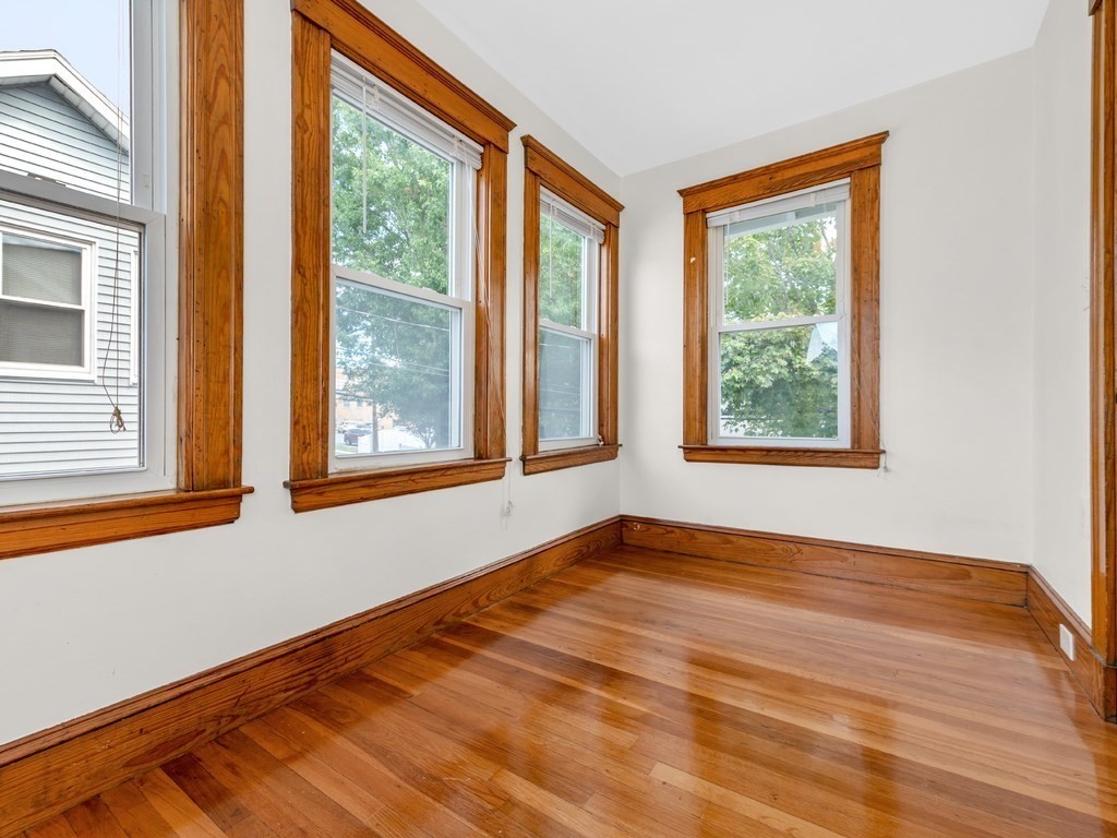 194 School Street, Unit 194 Watertown, MA 02472 - Photo 16 of 24 a view of an empty room with wooden floor and a window
