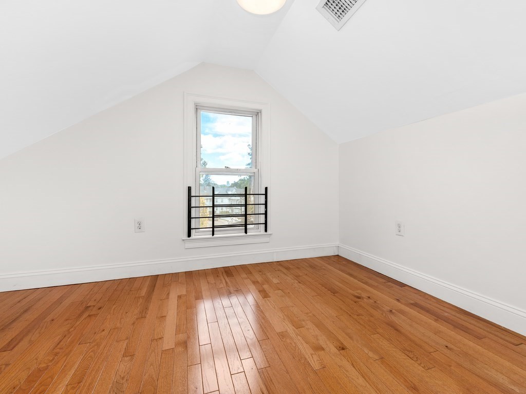194 School Street, Unit 194 Watertown, MA 02472 - Photo 18 of 24 an empty room with wooden floor and windows