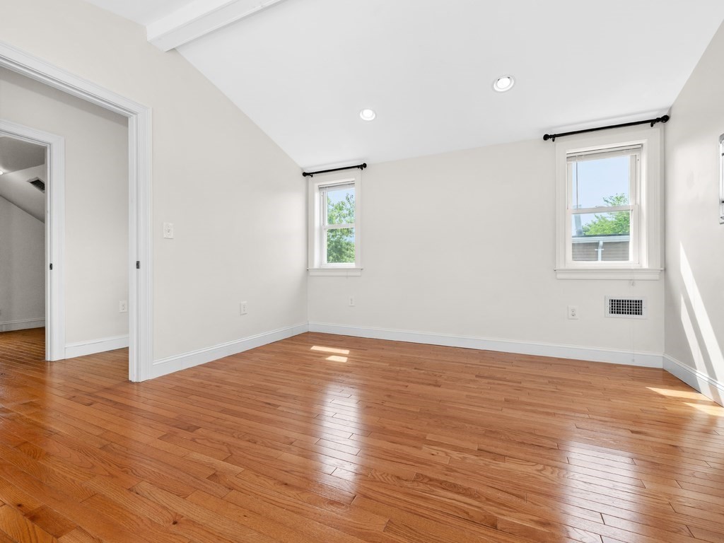 194 School Street, Unit 194 Watertown, MA 02472 - Photo 19 of 24 an empty room with wooden floor and windows
