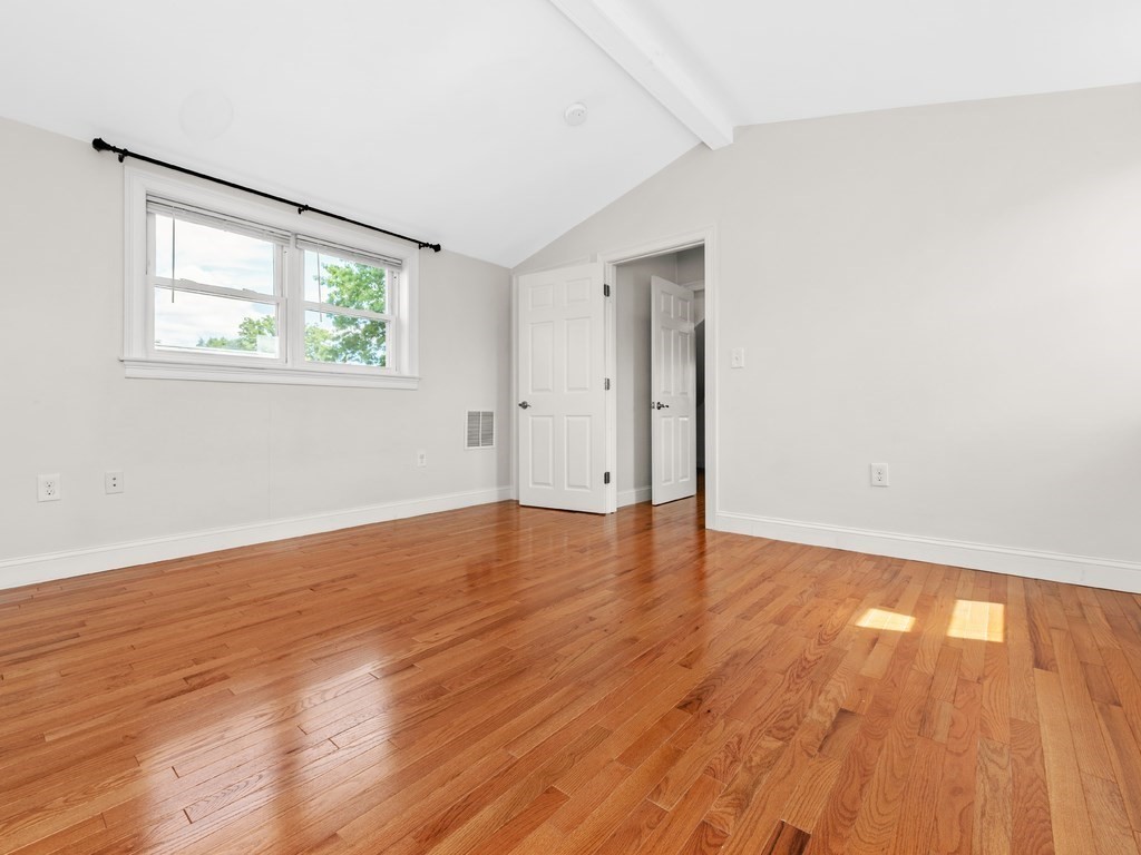 194 School Street, Unit 194 Watertown, MA 02472 - Photo 20 of 24 an empty room with wooden floor and windows