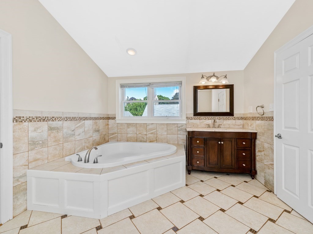 194 School Street, Unit 194 Watertown, MA 02472 - Photo 22 of 24 a spacious bathroom with a tub sink and mirror