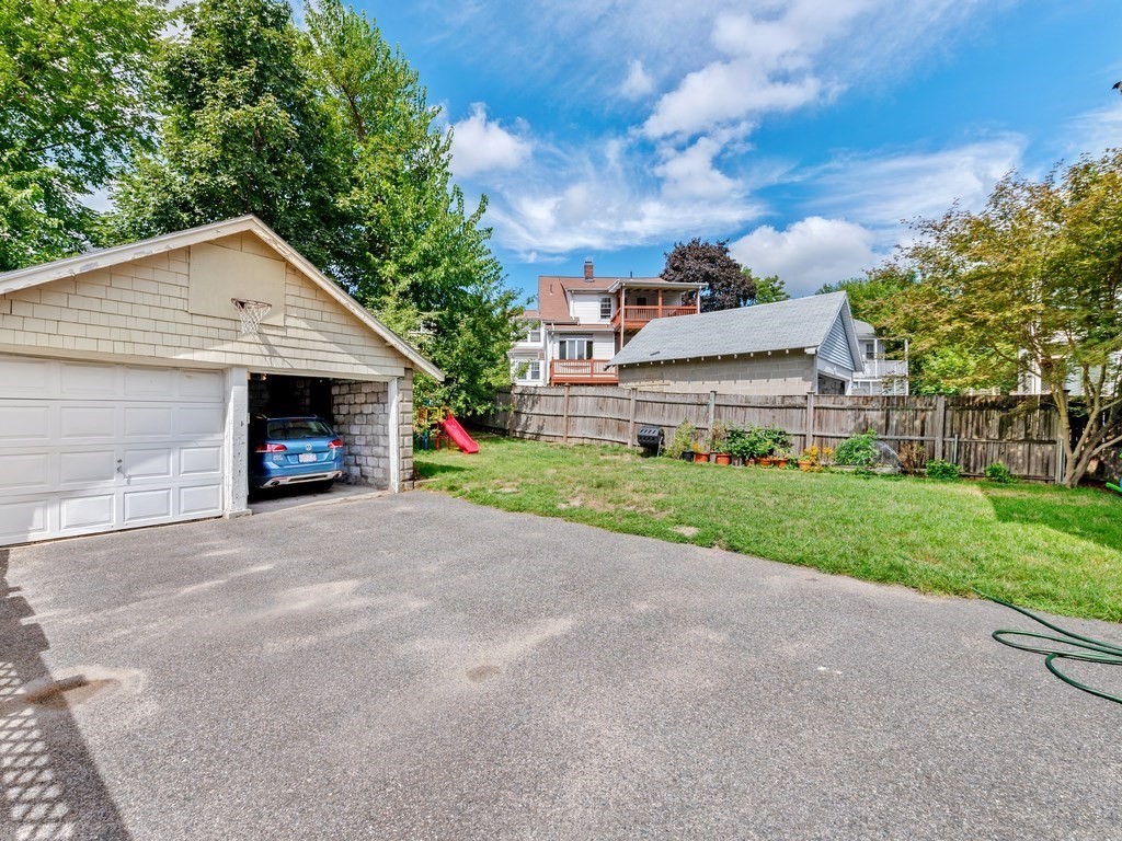 194 School Street, Unit 194 Watertown, MA 02472 - Photo 24 of 24 a front view of a house with a yard and garage