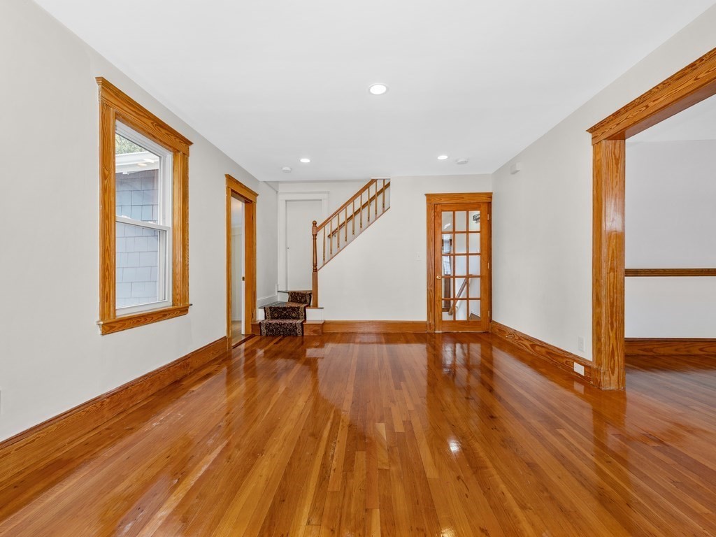 194 School Street, Unit 194 Watertown, MA 02472 - Photo 4 of 24 a view of an empty room with wooden floor and a window