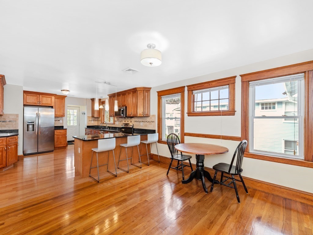 194 School Street, Unit 194 Watertown, MA 02472 - Photo 6 of 24 a view of a dining room with furniture window and wooden floor