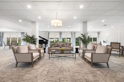 a living room with furniture and a chandelier