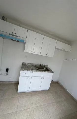 a kitchen with a sink and cabinets
