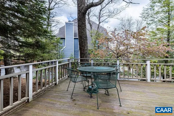a view of balcony with wooden floor and outdoor seating