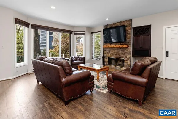a living room with furniture flat screen tv and a fireplace