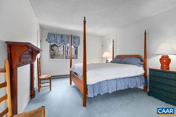 a bedroom with a bed and a mirror