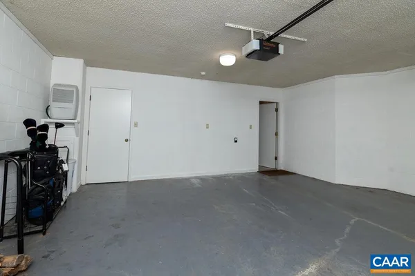 an empty room with a ceiling fan and windows