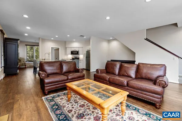 a living room with furniture and a rug