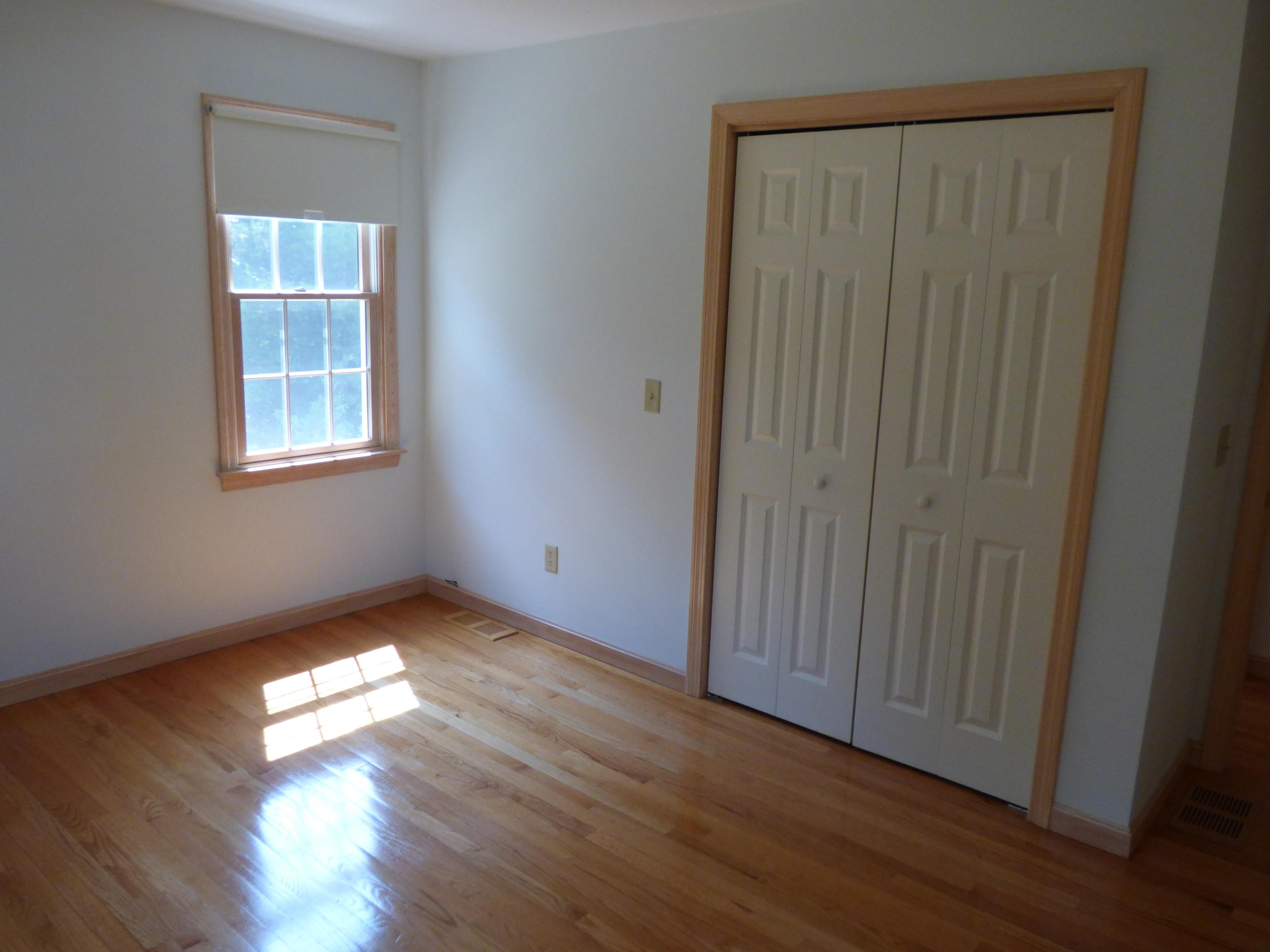 229 Woodside Road West Barnstable, MA 02668 - Photo 12 of 26 a view of empty room with wooden floor and fan