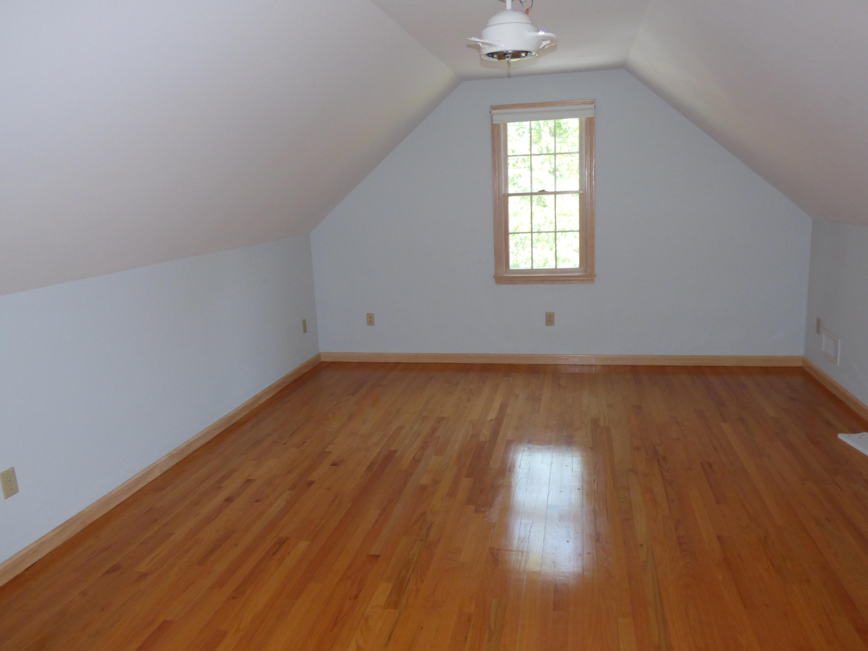 229 Woodside Road West Barnstable, MA 02668 - Photo 13 of 26 an empty room with wooden floor and windows