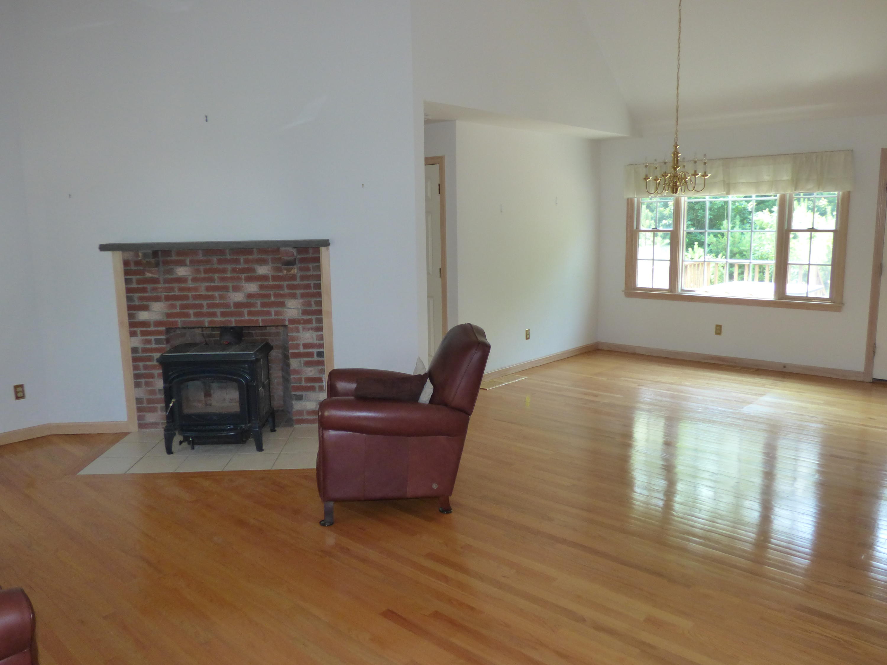 229 Woodside Road West Barnstable, MA 02668 - Photo 3 of 26 a living room with furniture and a fireplace