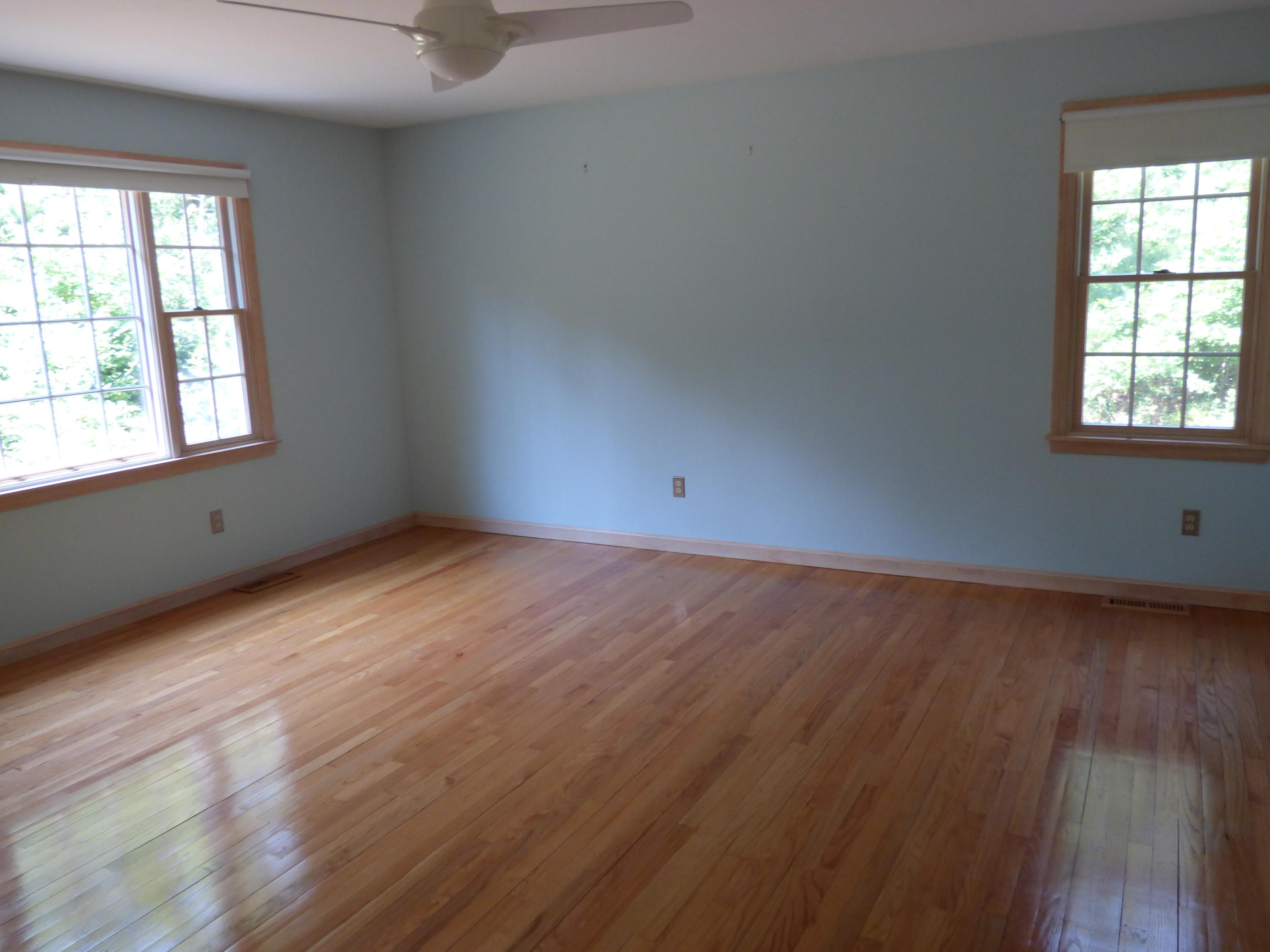 229 Woodside Road West Barnstable, MA 02668 - Photo 6 of 26 an empty room with wooden floor and windows