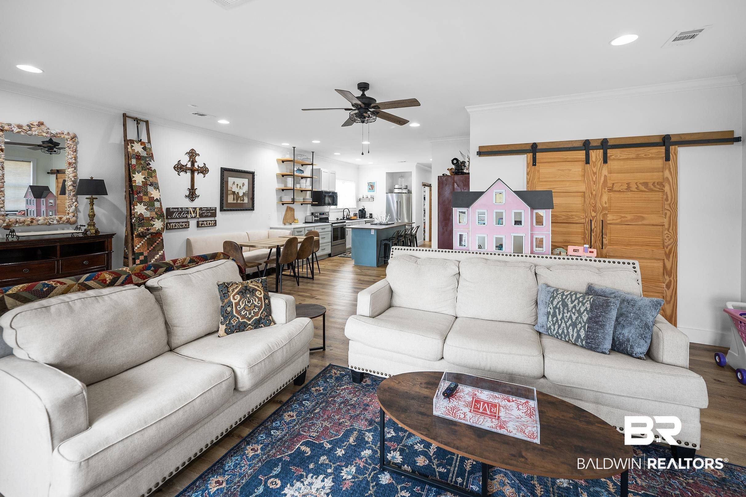 8490 Bay View Drive Foley, AL 36535 - Photo 48 of 67 Living room featuring a barn door, ceiling fan, crown molding, dark wood-type flooring, and recessed lighting