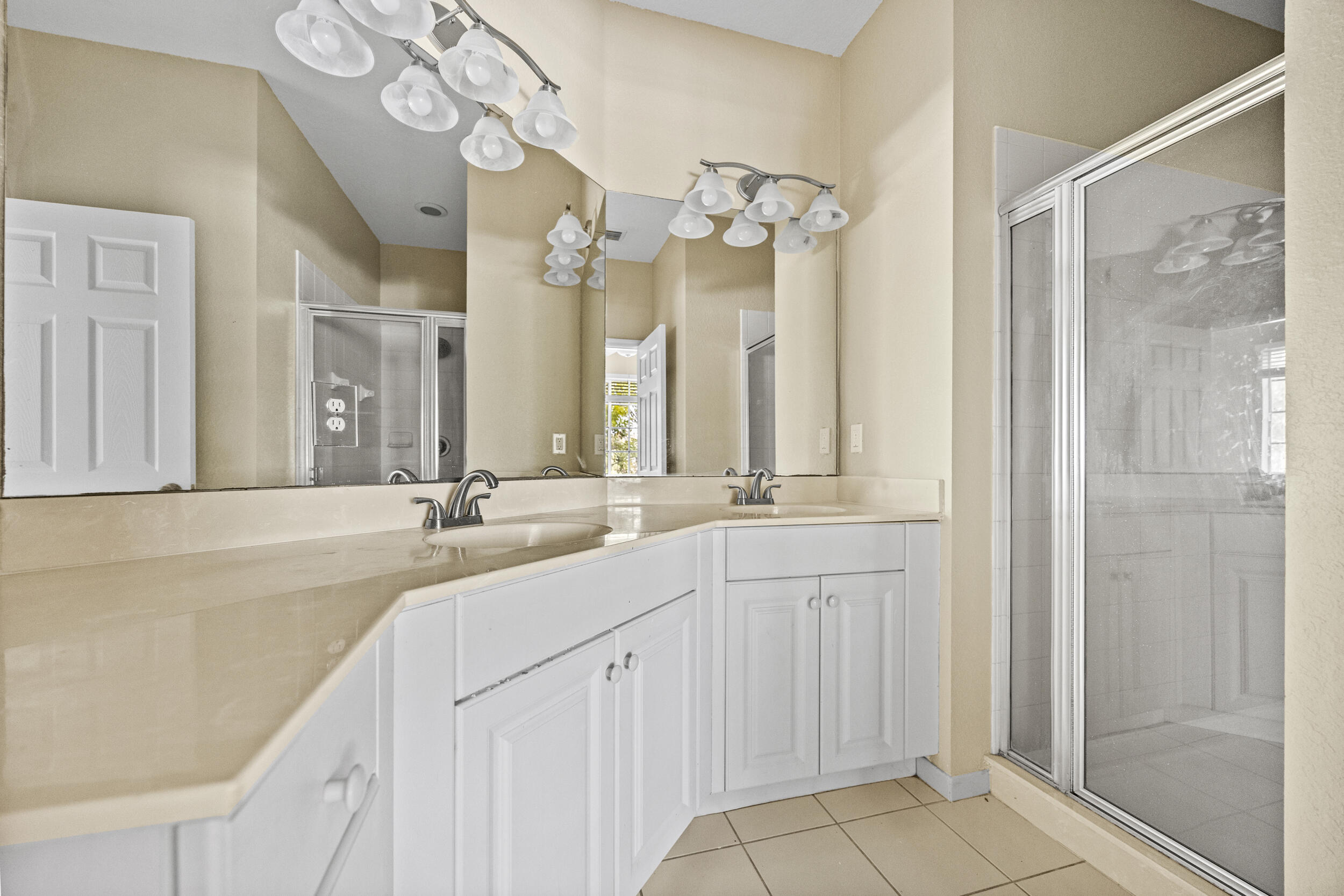 1982 Freeport Drive Riviera Beach, FL 33404 - Photo 15 of 31 a bathroom with a double vanity sink mirror and shower