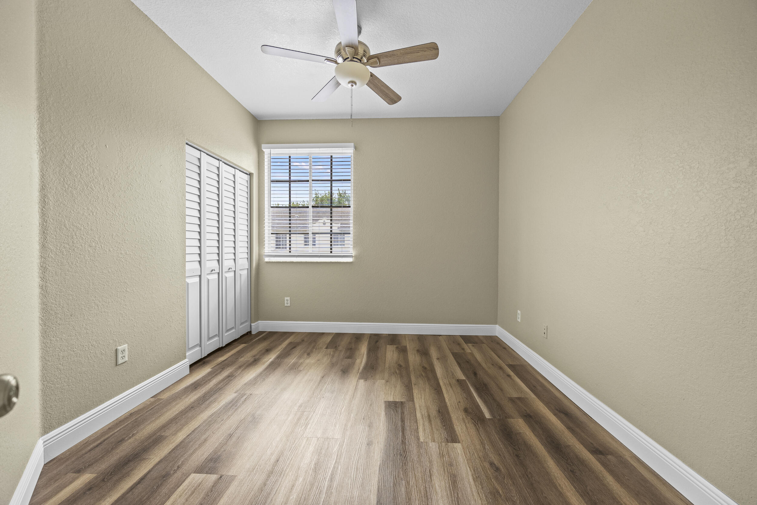 1982 Freeport Drive Riviera Beach, FL 33404 - Photo 2 of 31 wooden floor in an empty room with a window