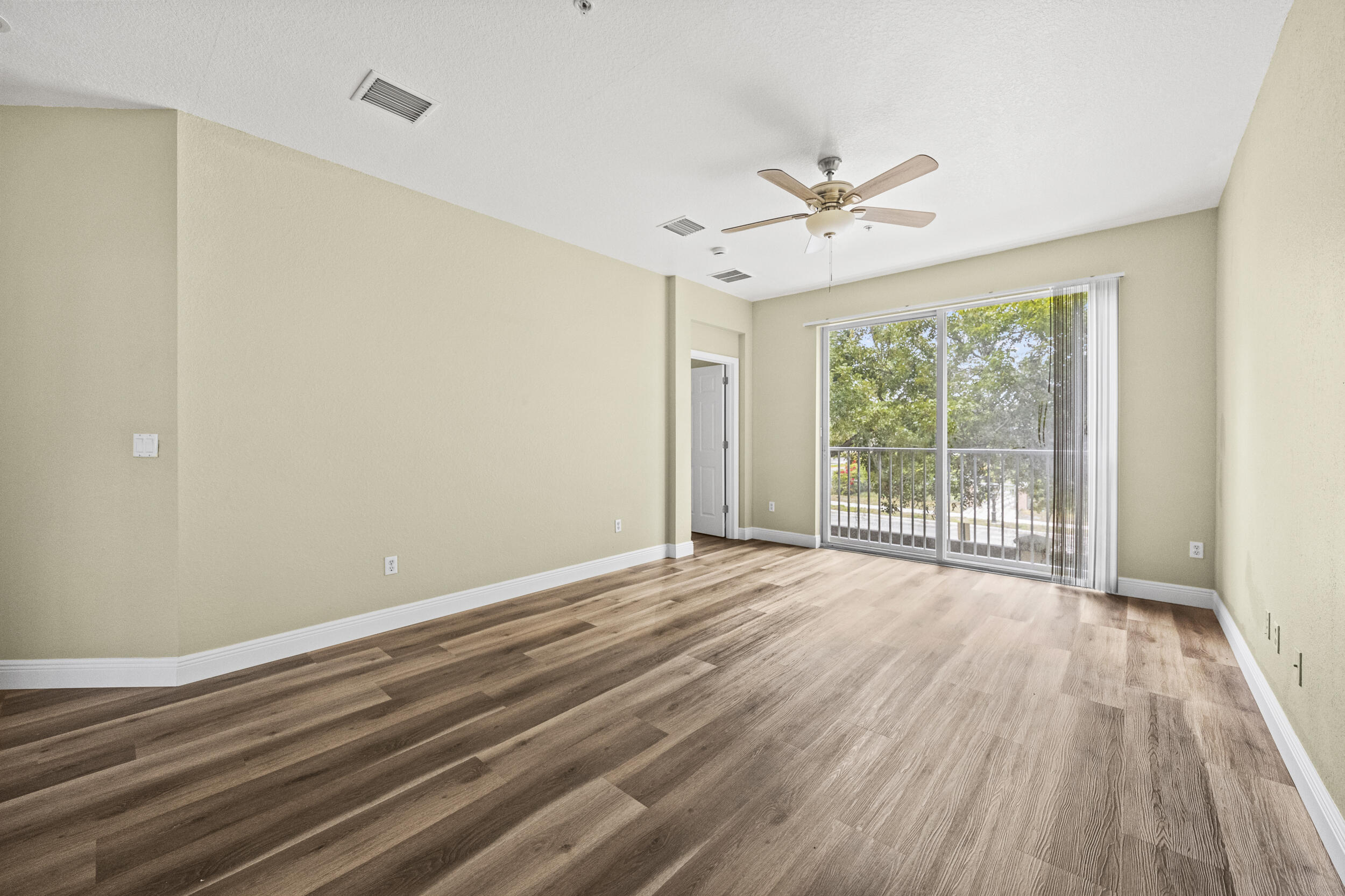 1982 Freeport Drive Riviera Beach, FL 33404 - Photo 22 of 31 a view of room with window ceiling fan and hardwood floor