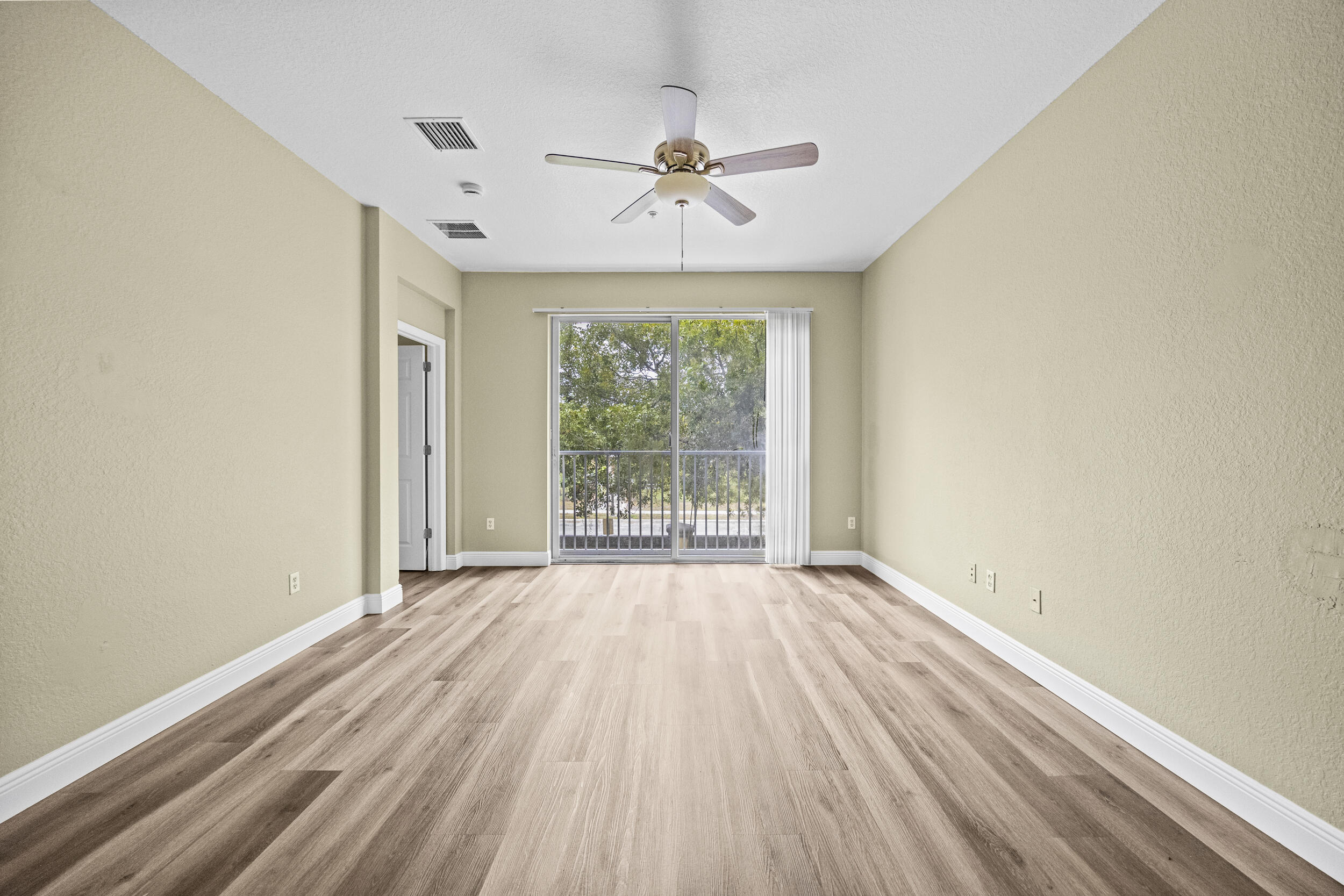 1982 Freeport Drive Riviera Beach, FL 33404 - Photo 23 of 31 a view of an empty room with wooden floor and a window