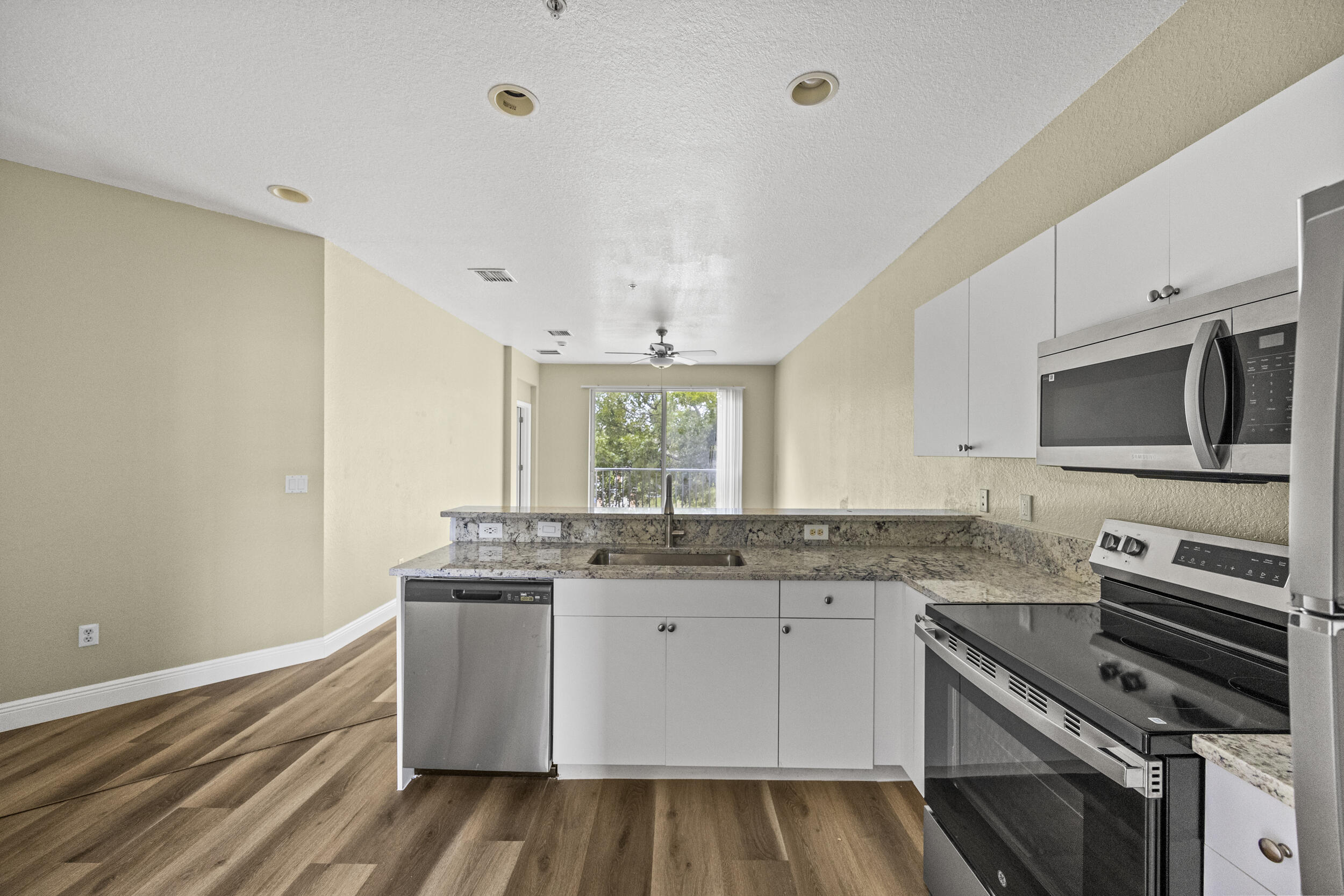 1982 Freeport Drive Riviera Beach, FL 33404 - Photo 26 of 31 a kitchen with a sink stove and microwave