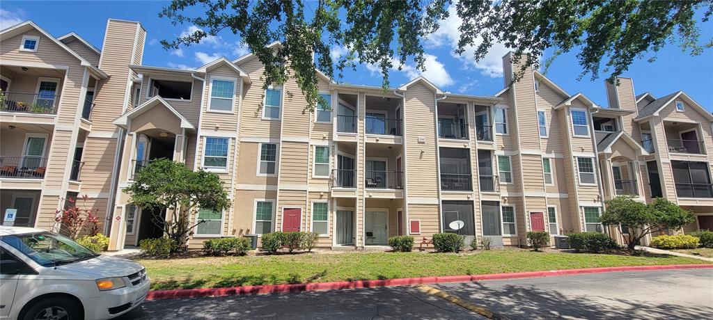 a front view of a residential apartment building with a yard