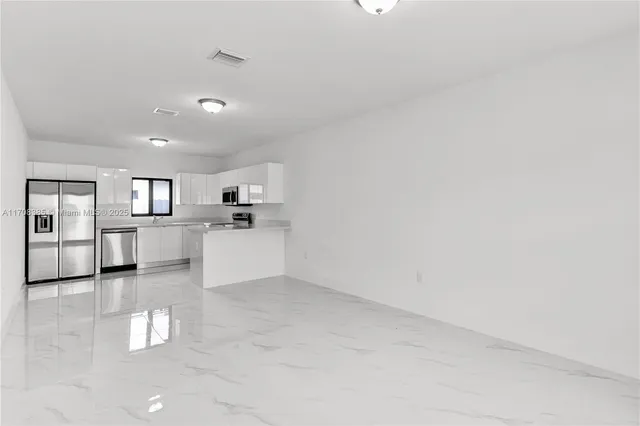 a view of a kitchen with a sink