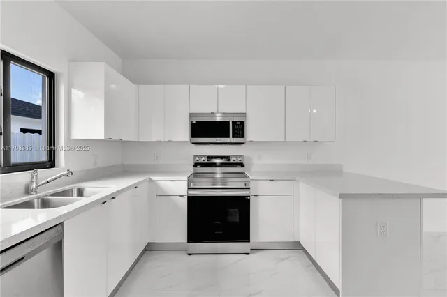 a kitchen with a stove and a sink