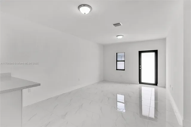 a view of an empty room with a window