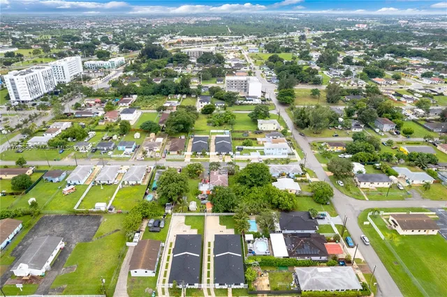 an aerial view of residential houses with outdoor space