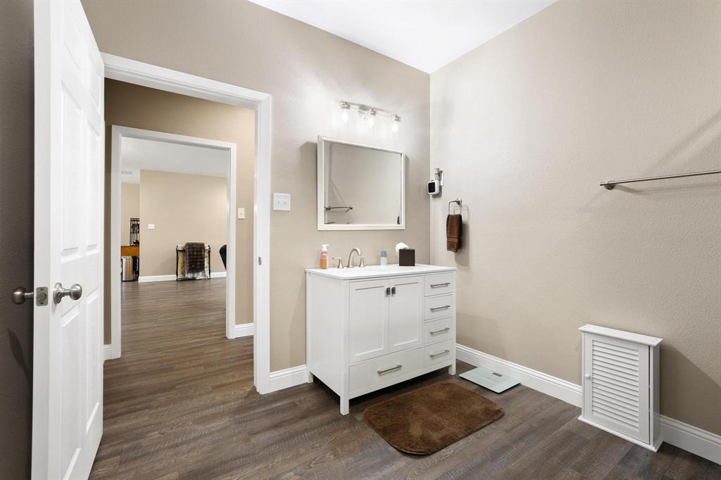 2658 Oak Ridge Road Denison, TX 75021 - Photo 24 of 37 a view of a hallway with bathroom and wooden floor