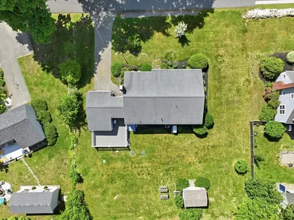 an aerial view of a house with a yard