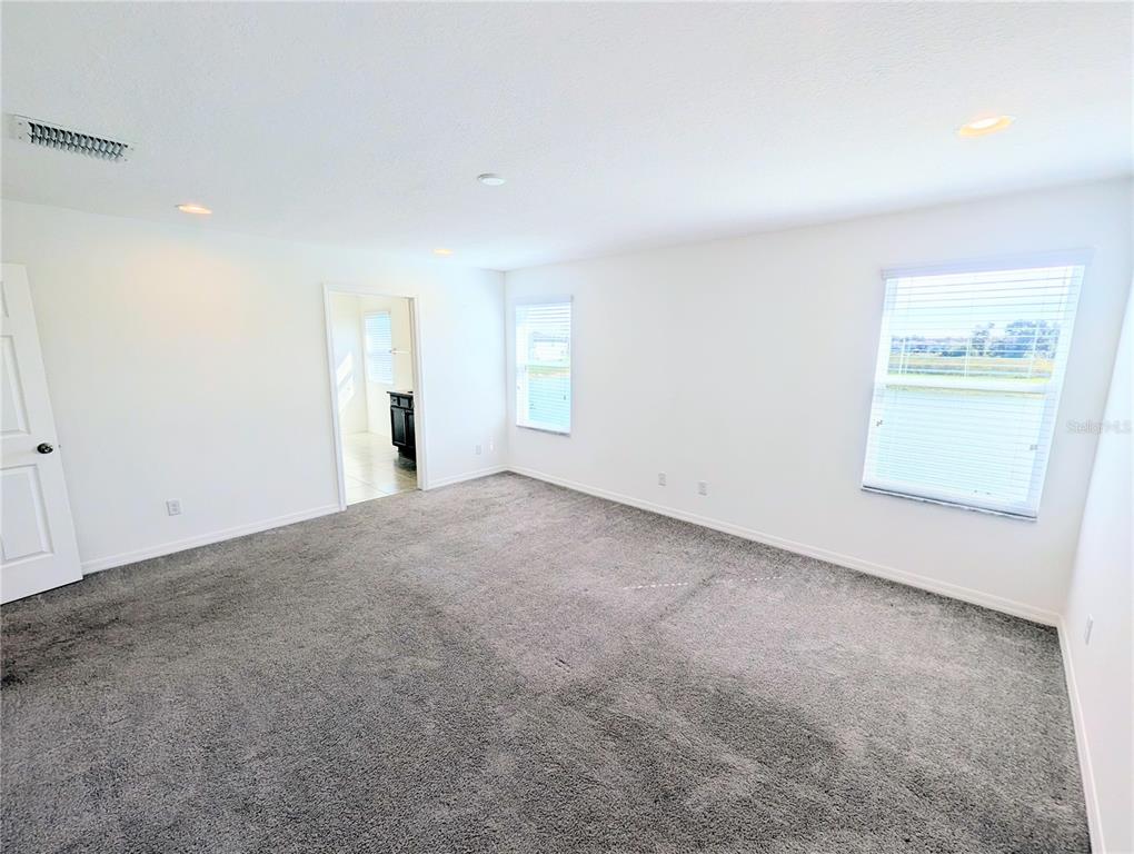 2944 Autumn Rock Drive Zephyrhills, FL 33540 - Photo 12 of 44 an empty room with windows and closet