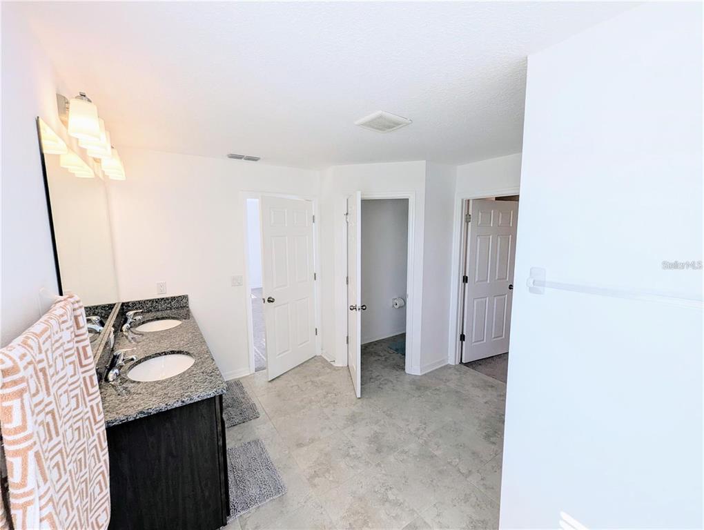2944 Autumn Rock Drive Zephyrhills, FL 33540 - Photo 16 of 44 a bathroom with a granite countertop sink and shower