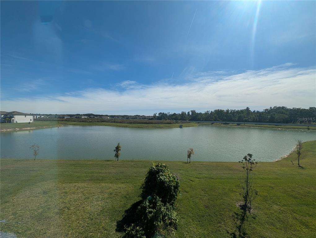 2944 Autumn Rock Drive Zephyrhills, FL 33540 - Photo 19 of 44 a view of a lake with houses in the back