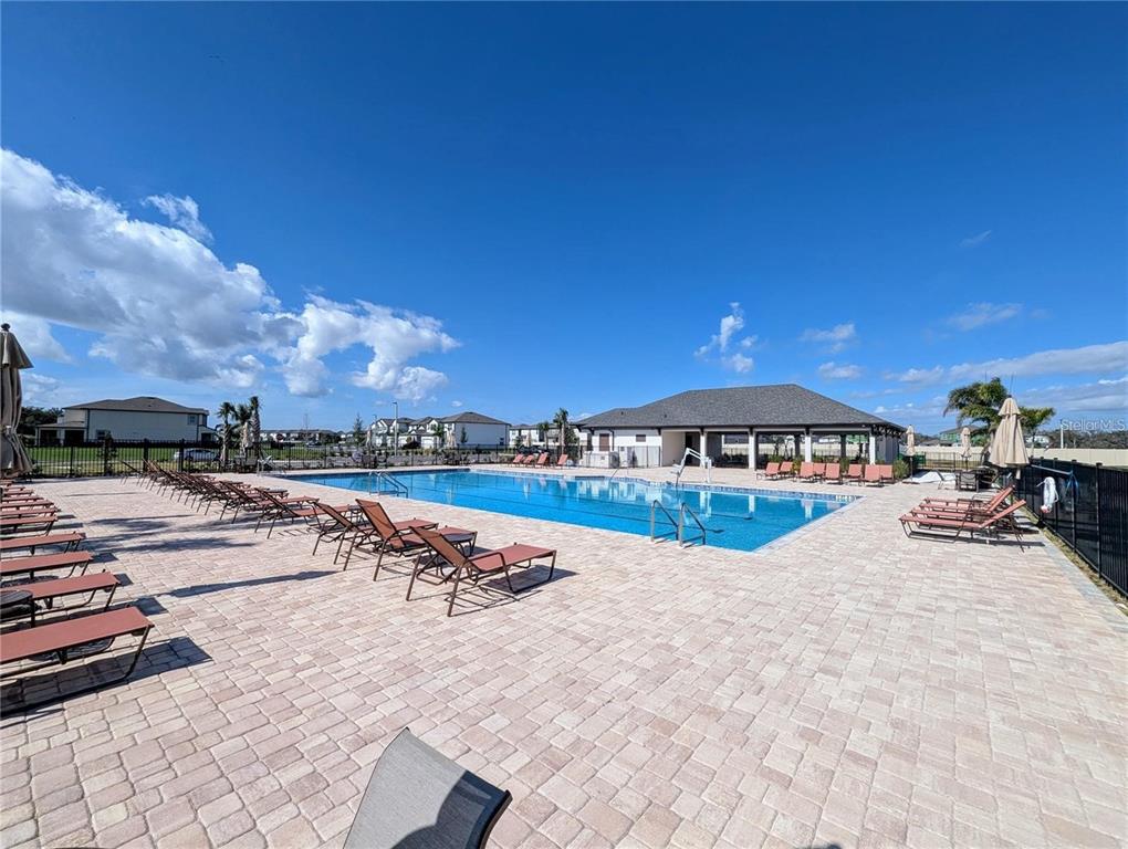 2944 Autumn Rock Drive Zephyrhills, FL 33540 - Photo 41 of 44 a view of a swimming pool and lounge chair