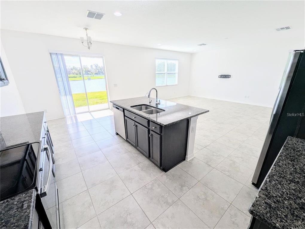 2944 Autumn Rock Drive Zephyrhills, FL 33540 - Photo 6 of 44 a kitchen with stainless steel appliances granite countertop a stove and a sink