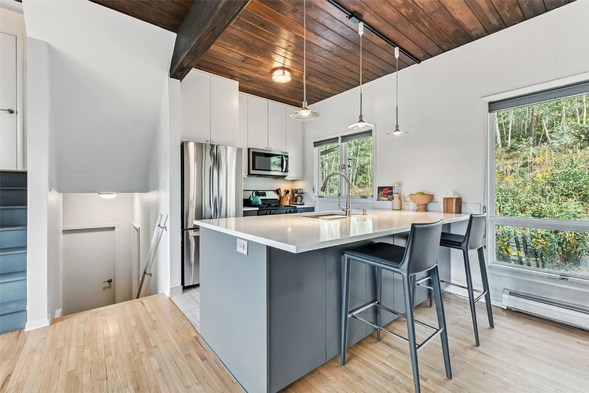 218 Deer Path Road Dillon, CO 80435 - Photo 11 of 49 a kitchen with stainless steel appliances a table chairs refrigerator and sink