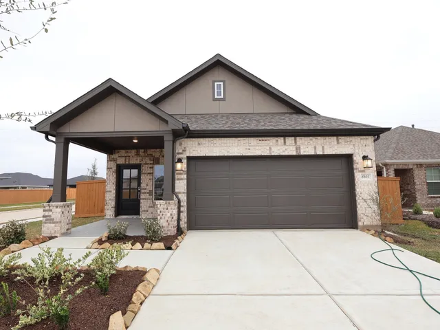 a front view of a house with garage