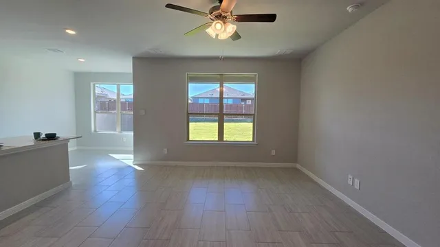 an empty room with a window and fireplace