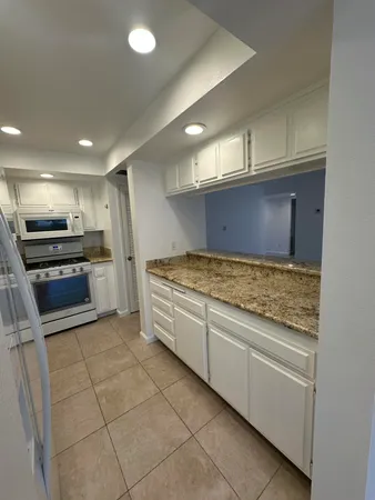a kitchen with stainless steel appliances granite countertop a stove and a sink