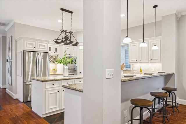 a view of a wooden chairs and table in the backyard