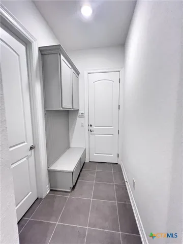 a view of kitchen with white cabinets and white appliances