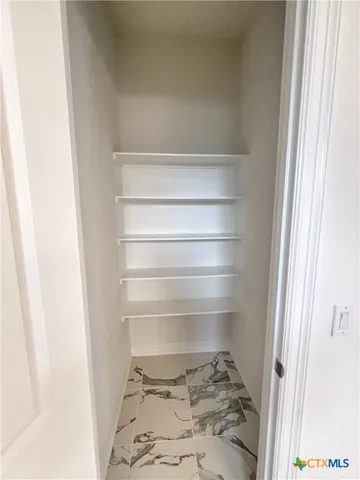a view of a kitchen with a sink and a refrigerator