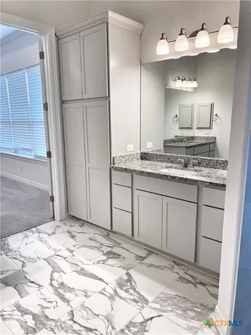 a bathroom with a sink and a mirror