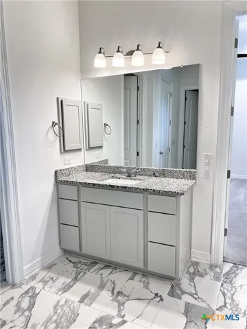 a large kitchen with stainless steel appliances kitchen island granite countertop a large counter top and a stove top oven