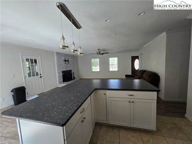 a kitchen with a sink dishwasher and a stove with wooden floor