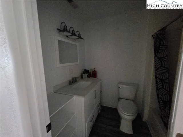 a bathroom with a sink toilet and vanity