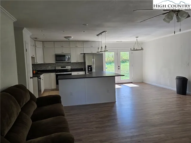 a kitchen with stainless steel appliances a refrigerator sink and cabinets