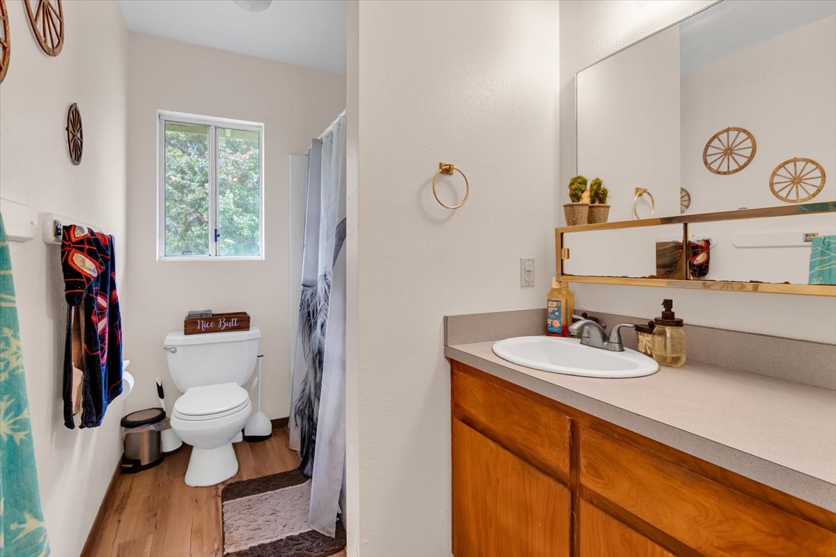 18-4327 North Peck Road Mountain View, HI 96771 - Photo 15 of 30 a bathroom with a toilet sink and mirror
